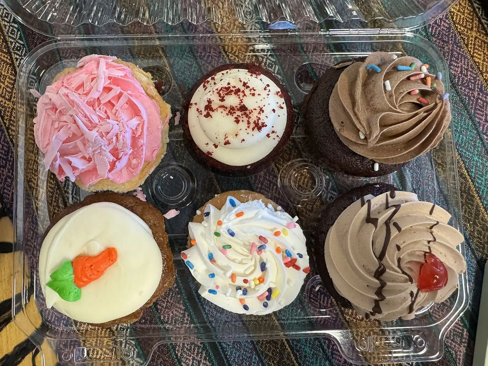 Frosted cupcakes in a bakery case in Napa, California. The photo was not taken in Wake Forest.