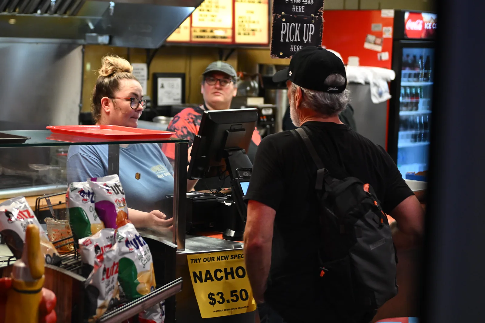 Customers order at the counter of a downtown Wake Forest eatery during a Friday Night on White concert.