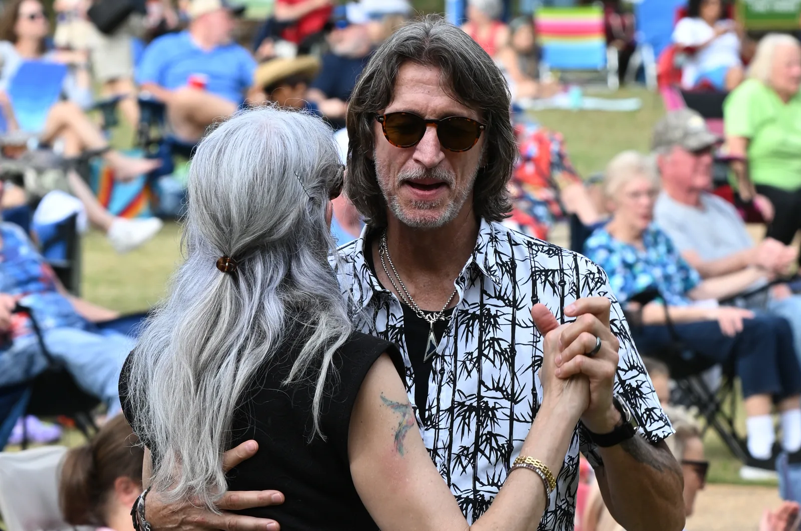 A couple dances on the lawn at E. Carroll Joyner Park in Wake Forest during a Six Sundays in Spring concert.