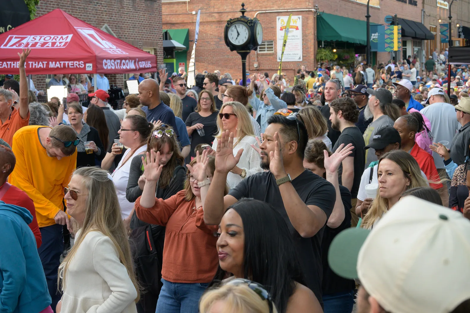 A crowd fills South White Street beside the downtown clock in Wake Forest during a Friday Night on White concert.
