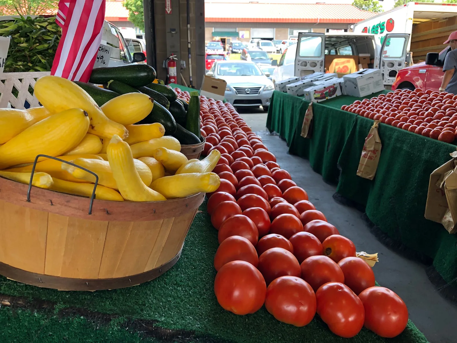 Yellow squash, zucchini and tomatoes stacked on a produce stand at the N.C. State Farmers Market in Raleigh.
