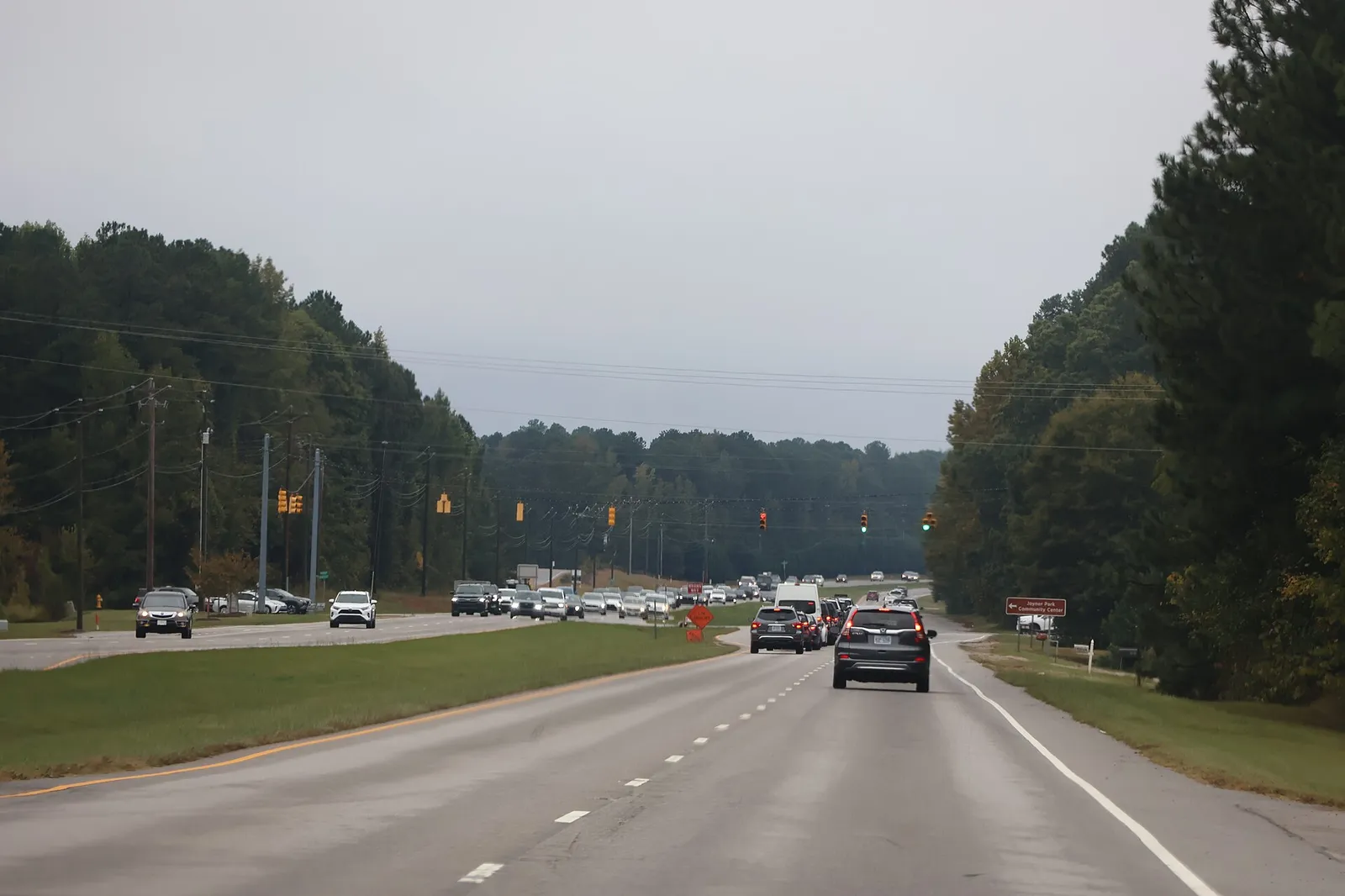 Traffic on Capital Boulevard (U.S. 1) in Wake Forest near the turn for Joyner Park, with a road work sign in the southbound lanes.