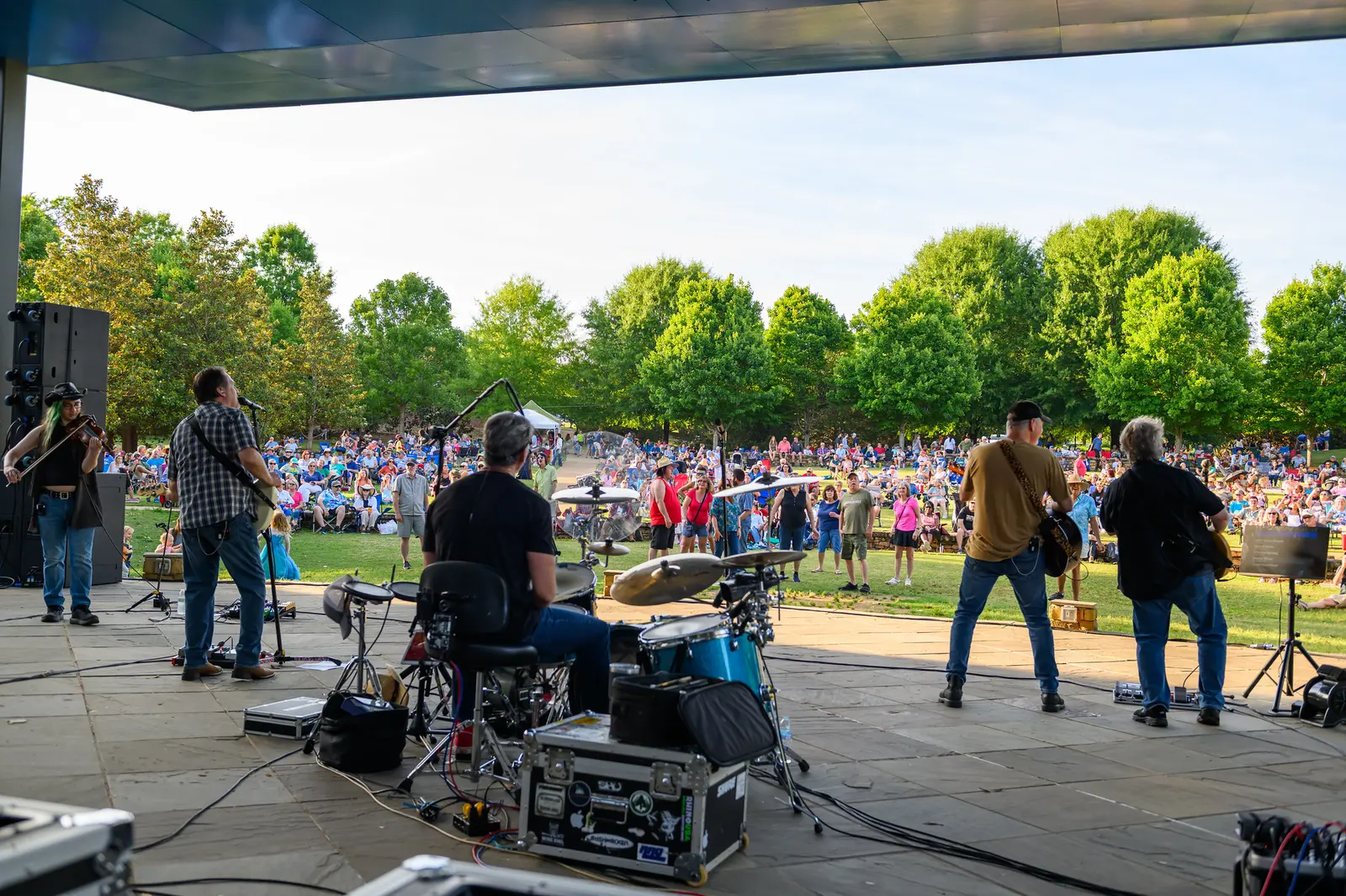 A band plays on the amphitheater stage at E. Carroll Joyner Park in Wake Forest as a big lawn crowd watches during Six Sundays in Spring.