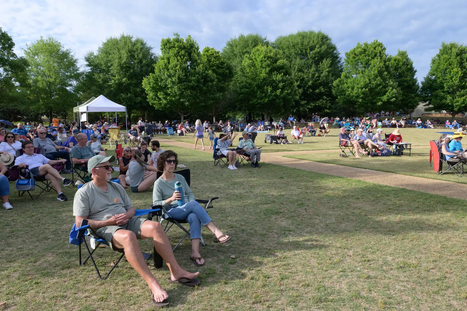 Families spread out on the lawn at E. Carroll Joyner Park in Wake Forest for a Six Sundays in Spring concert.