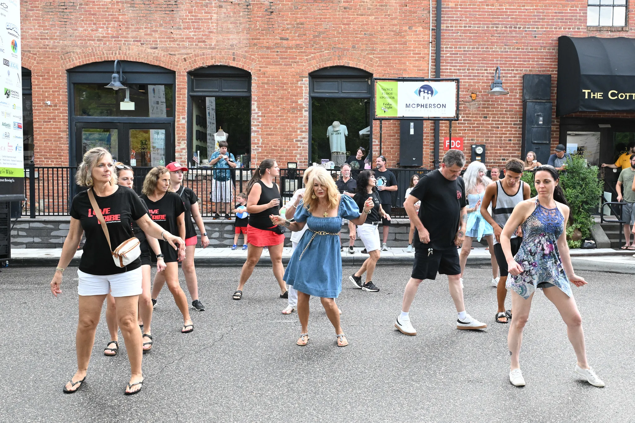 Dancers fill South White Street outside brick storefronts in downtown Wake Forest during a Friday Night on White concert.