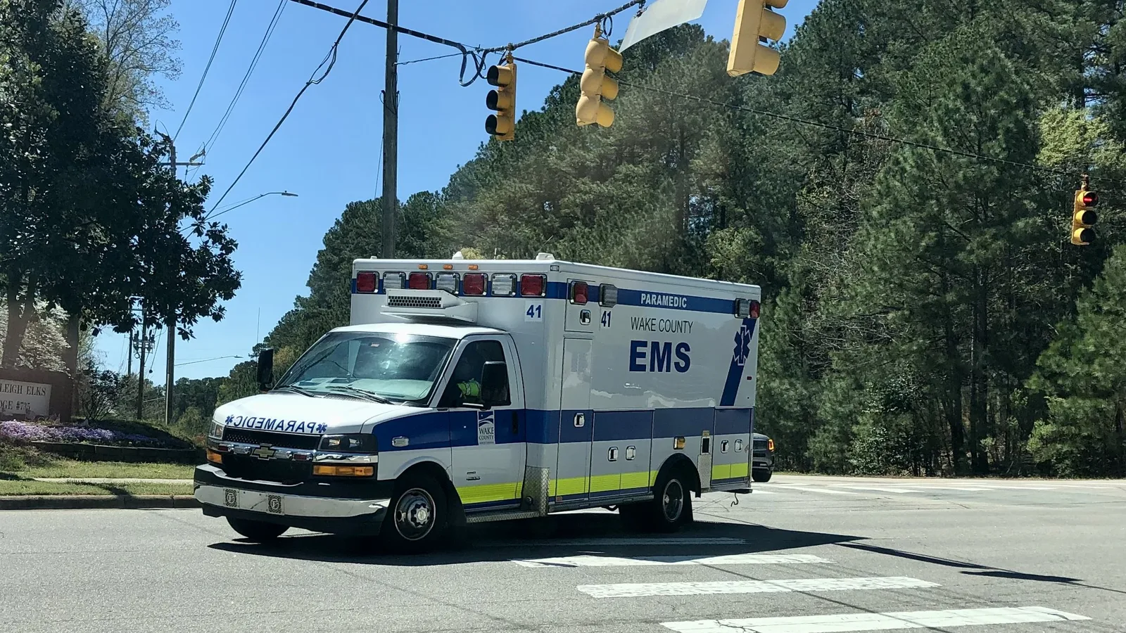 A Wake County EMS paramedic ambulance crosses an intersection in Raleigh.