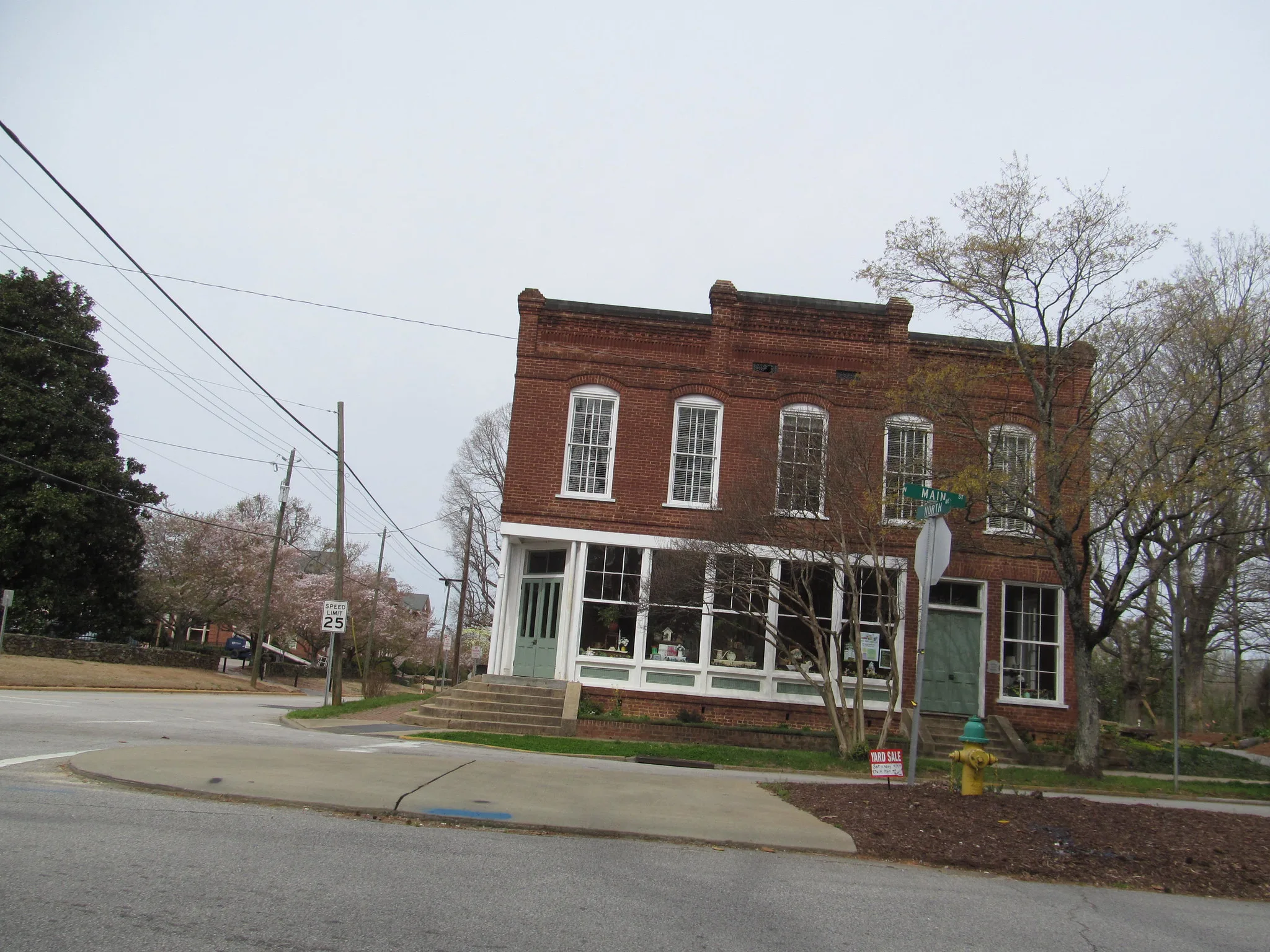 A two-story brick building on a corner of Main Street in Wake Forest.