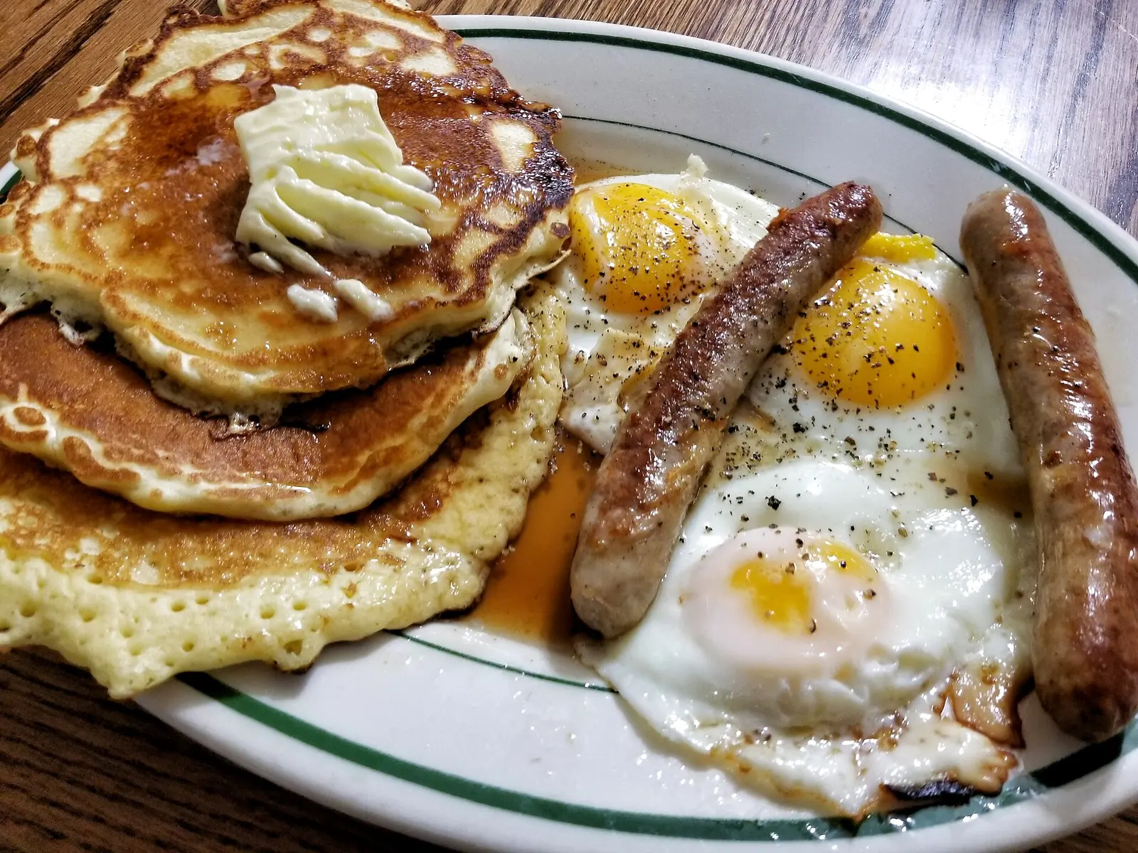 A breakfast plate of pancakes, sausage and eggs. The photo was not taken at a Wake Forest restaurant.